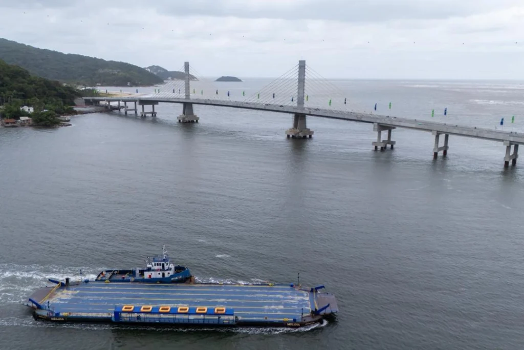 Ponte de Guaratuba sobre a baía com balsa navegando no litoral do Paraná.