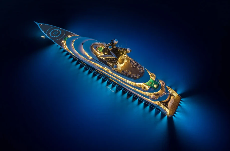 Megaiate Kismet iluminado durante a noite, com heliponto e áreas de lazer visíveis.