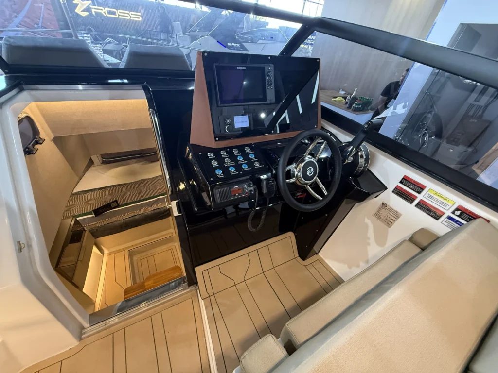 Piso para barco Thermo Deck Beach da Kapazi Náutica com acabamento amadeirado e frisos pretos na cabine e posto de comando de uma lancha.